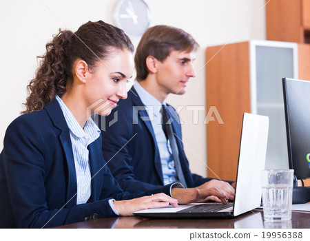 two employees in modern office 19956388