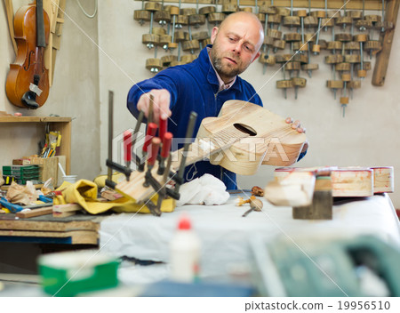 Guitar-maker at workshop Guitar-maker at workshop 19956510