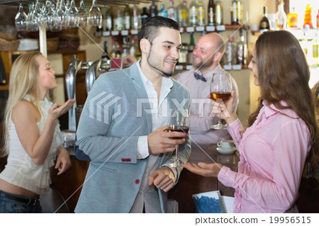 Couple drinking wine at bar 19956515