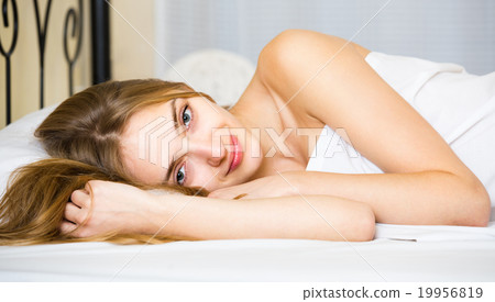 Portrait of pretty girl awake in bed. 19956819