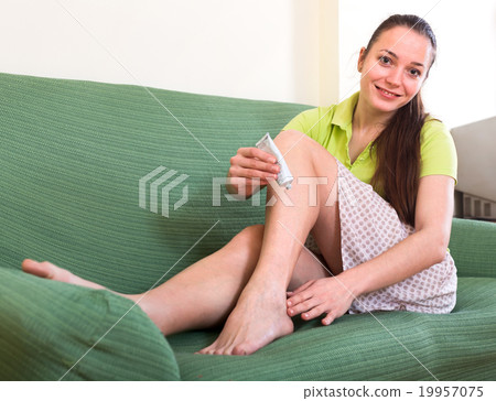 Woman treating callosity on foot 19957075