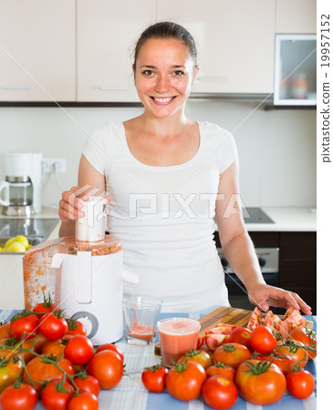 Girl preparing fresh juice in kitchen Girl preparing fresh juice in kitchen 19957152
