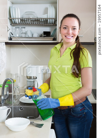 Smiling housewife washing dishes 19957164