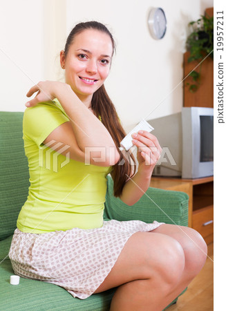 Woman sitting with treatment 19957211