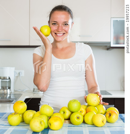 woman cooking dish from apples 19957215