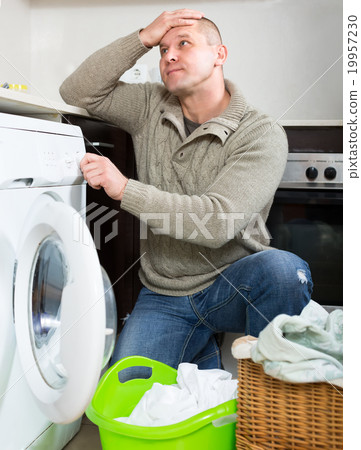 Man and washing machine 19957230