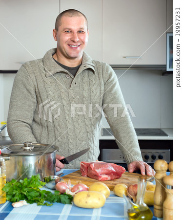 Man cooking meat 19957231
