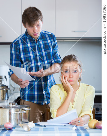 spouses discussing bills and banking statement spouses discussing bills and banking statement 19957366