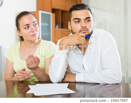 couple with documents in apartment 19957997