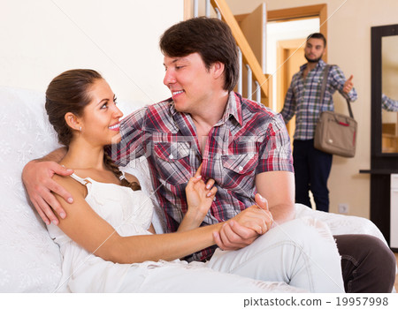Surprised young husband coming home 19957998