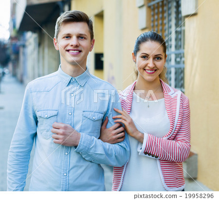 Cheerful girl and handsome man having a walk together Cheerful girl and handsome man having a walk together 19958296