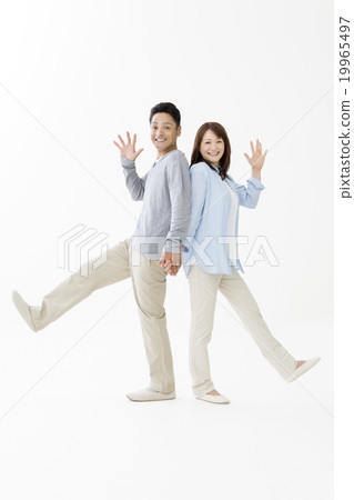 A couple standing back to back 19965497