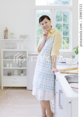 A Japanese woman standing in the kitchen 19965531
