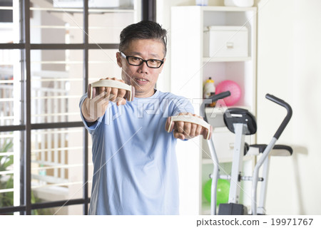 asian senior male with dumbell in the gym asian senior male with dumbell in the gym 19971767