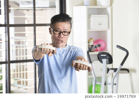 asian senior male with dumbell in the gym 19971769