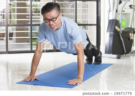 asian senior male streching at the gym 19971779