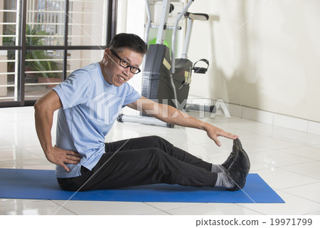 Asian man in sportswear doing leg stretching Asian man in sportswear doing leg stretching 19971799