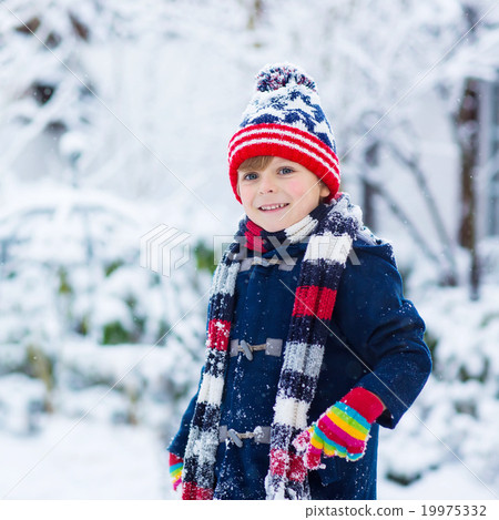 Happy child having fun with snow in winter Happy child having fun with snow in winter 19975332