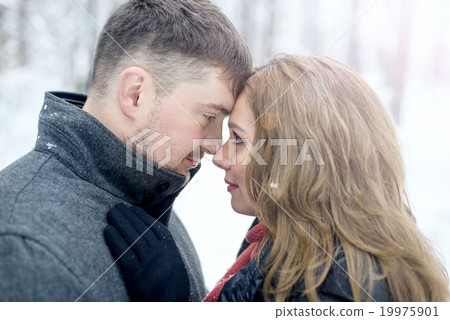 Portrait of happy couple in winter park 19975901