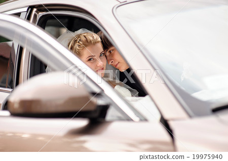 bride and groom kissing in wedding car bride and groom kissing in wedding car 19975940
