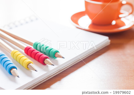 Pencils on open blank white notebook Pencils on open blank white notebook 19979602