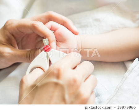 Mother cut baby finger nail carefully. Mother cut baby finger nail carefully. 19979960