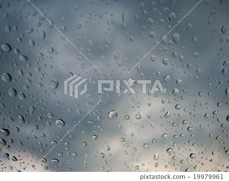 Raindrops on car glass with cloudy sky. Raindrops on car glass with cloudy sky. 19979961