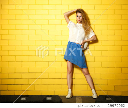 Street Style Hipster Fashion Girl at Yellow Wall 19979962
