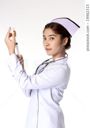 Young female nurse holding syringe Young female nurse holding syringe 19982315