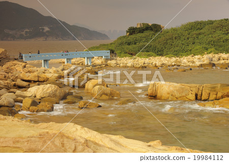 rocky sea coast and blurred water in shek o 19984112