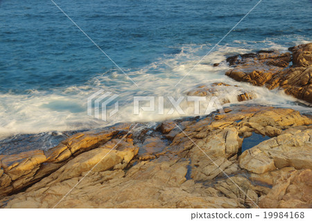 rocky sea coast and blurred water in shek o, 19984168
