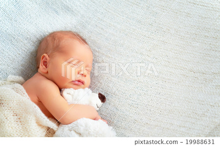 Stock Photo: Cute newborn baby sleeps with toy teddy bear