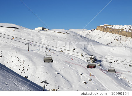 Ski slope and chair-lift at sun day 19990164