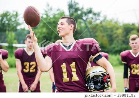 American Football player showing trick with ball 19991192
