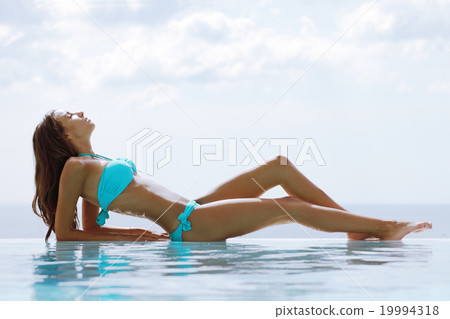 Woman in swimming pool Woman in swimming pool 19994318