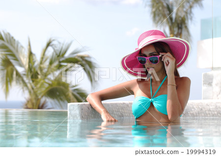 Woman in swimming pool Woman in swimming pool 19994319