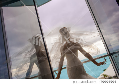 The bride is standing on the balcony. The bride is standing on the balcony. 19994594