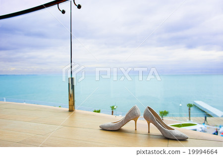 Bridal shoes near the fencing. Bridal shoes near the fencing. 19994664