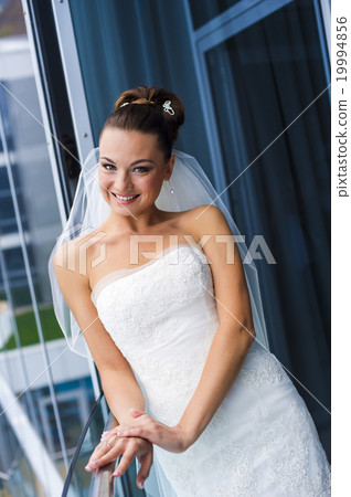 Fabulous bride near the window. 19994856