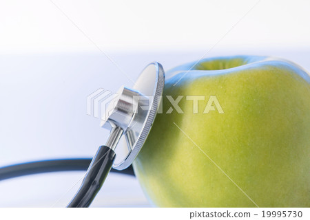 Green apple and stethoscope. Green apple and stethoscope. 19995730