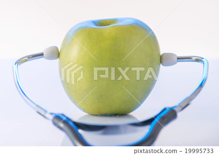 Green apple with doctors stethoscope. Green apple with doctors stethoscope. 19995733