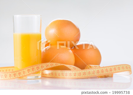 Oranges, fresh juice and measuring tape. Oranges, fresh juice and measuring tape. 19995738