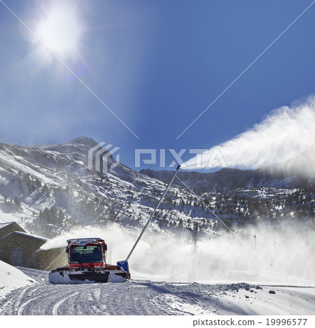 Red snow groomer in the mountain 19996577