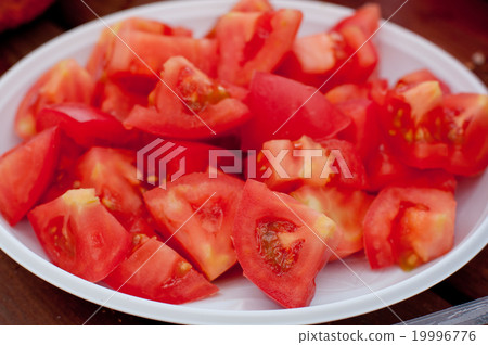 Tomato slices on white plate Tomato slices on white plate 19996776
