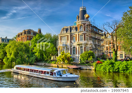 Boat on Amstel river near beautiful houses in 19997945