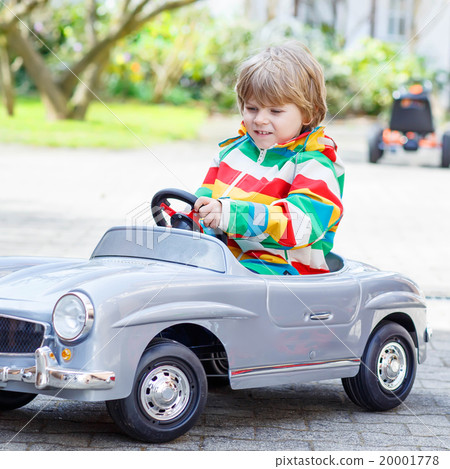 Two happy sibling boys playing with big old toy Two happy sibling boys playing with big old toy 20001778