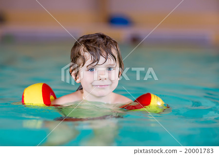 little kid boy with swimmies learning to swim in 20001783