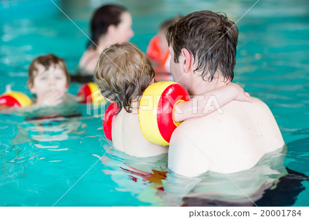 Young dad teaching his two little sons to swim Young dad teaching his two little sons to swim 20001784