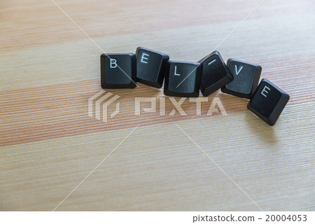 Belive word keyboard on wooden floor 20004053