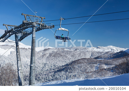 Ski lift with seats going over the mountain Ski lift with seats going over the mountain 20010104